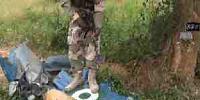  Boko Haram member standing on wreckage of a Nigerian jet fighter 